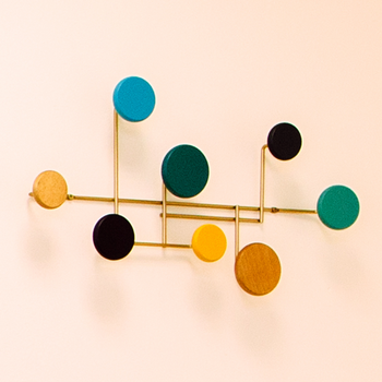 Modern, colorful design coat rack on the wall in a stylishly furnished recording studio.