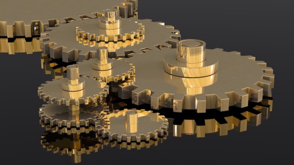 Golden gears in front of a reflecting surface